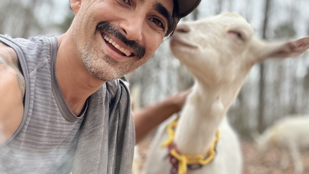 Farmer with a goat friend