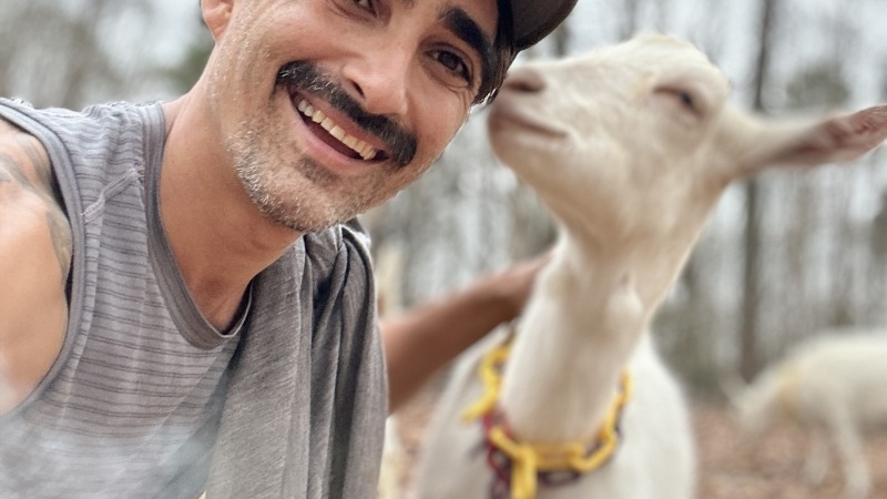 Farmer with a goat friend