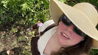 selfie of a girl in afield with a sunhat on 
